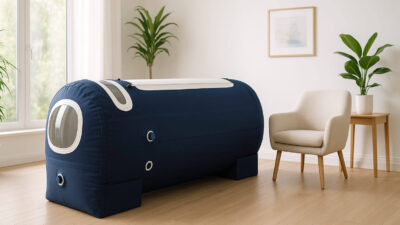 Modern home hyperbaric chamber setup in bright living room showing comfortable at-home oxygen therapy environment